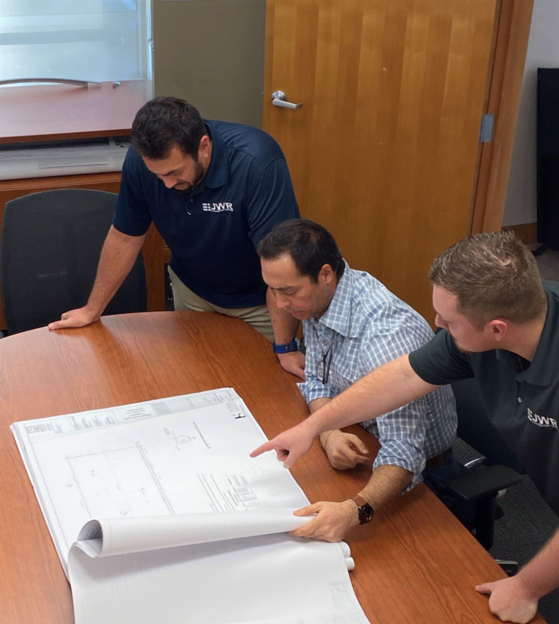 JWR team reviewing project plans with a client